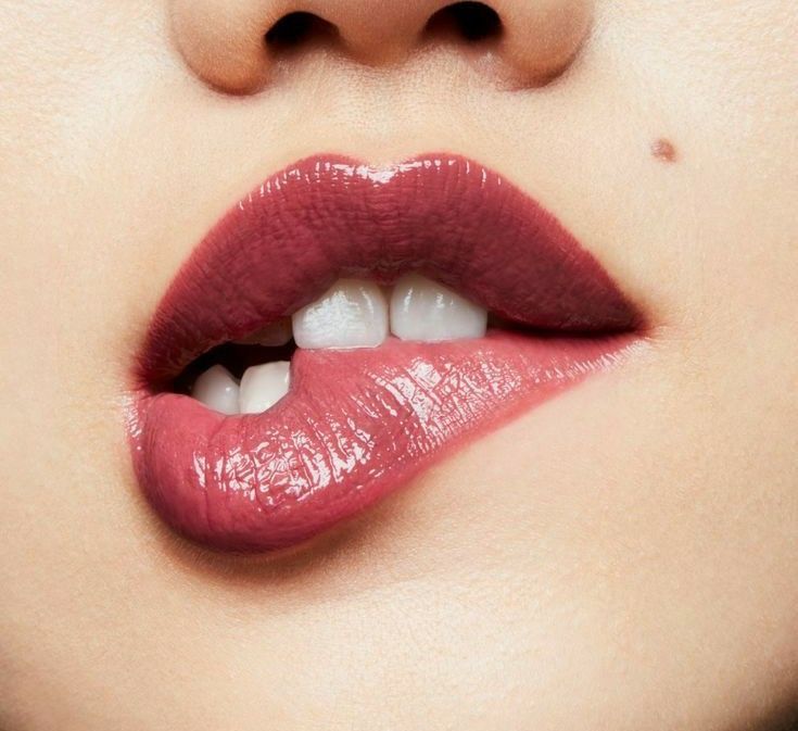 Close-up of glossy rose-coloured lips