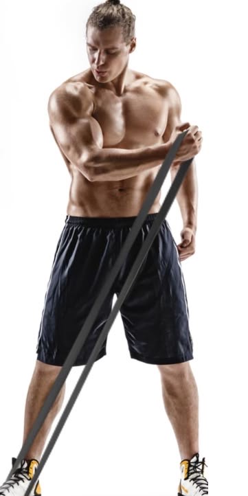 Man exercising with a long resistance band anchored under his foot