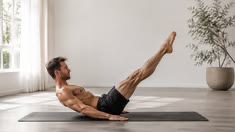 Man exercising on a yoga mat in a bright room