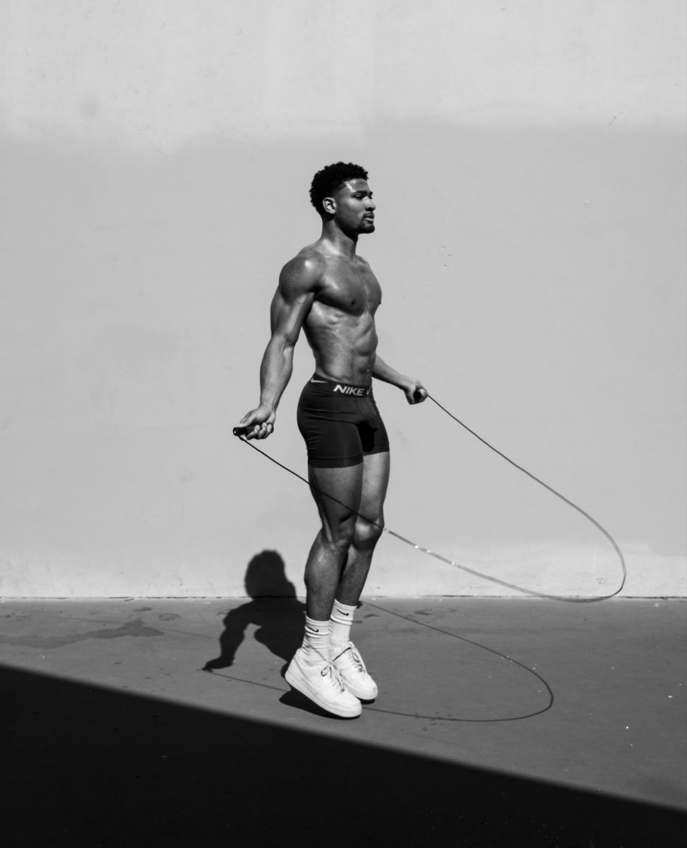 Man skipping rope outdoors in a black-and-white photograph